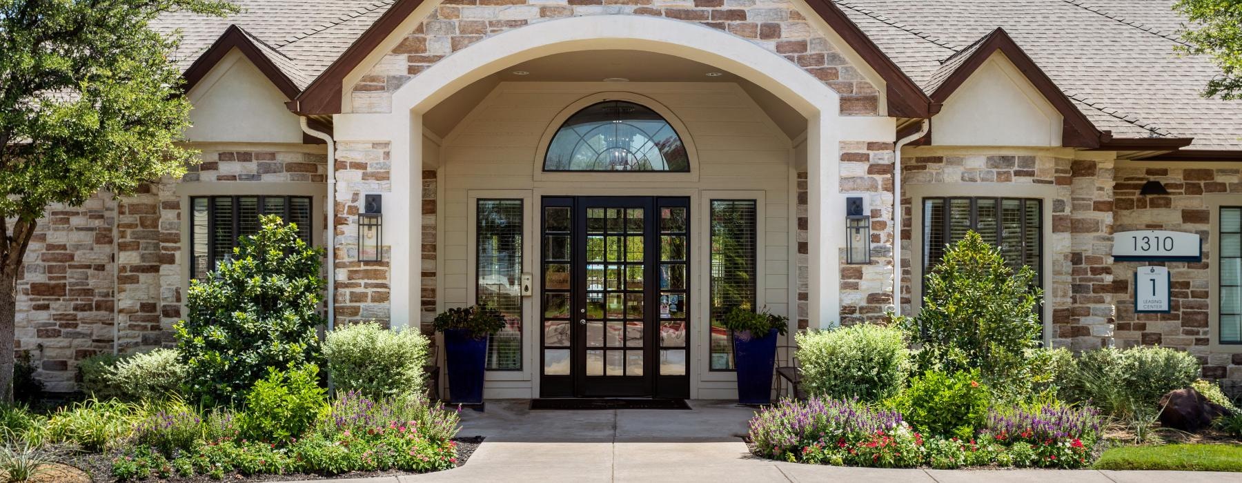 a building with a large front door entrance to clubhouse