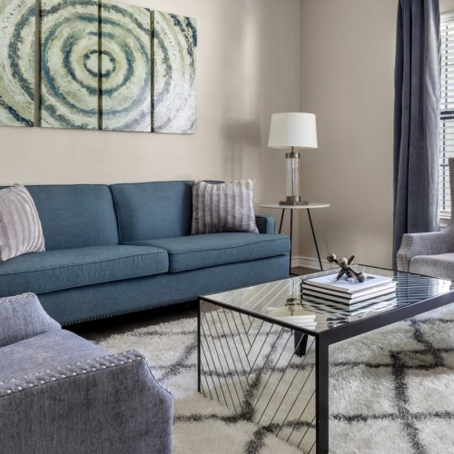 Generous living spaces with beautiful natural lighting a living room with a couch and a coffee table
