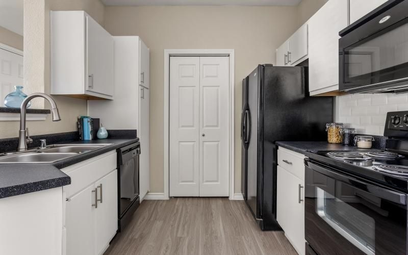 a kitchen with white cabinets